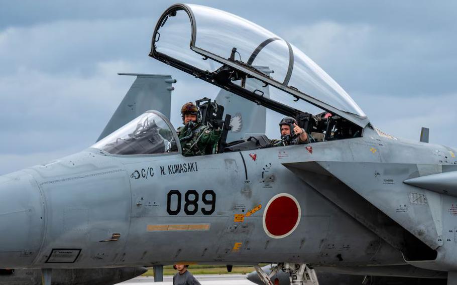 Japan Air Self-Defense Force Maj. Nagamine, left, and U.S. Air Force Maj. Jesse Ruter, weapons systems officer assigned to the 18th Operations Group, prepare to take off in a F-15DJ Eagle assigned to the 204th Fighter Squadron, at Naha Air Base, Japan.